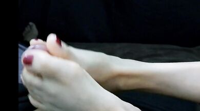 Her red nails tease my cock as her Latina feet worship me